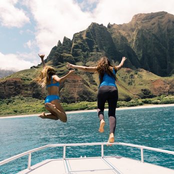 Na Pali Pirates - Jumping off the bow in front of Kalalau. - Boat Tours Near Me Na Pali Pirates - Jumping off the bow in front of Kalalau. - Boat Tours Near Me