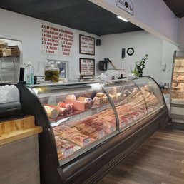 a variety of meats in a display case a variety of meats in a display case