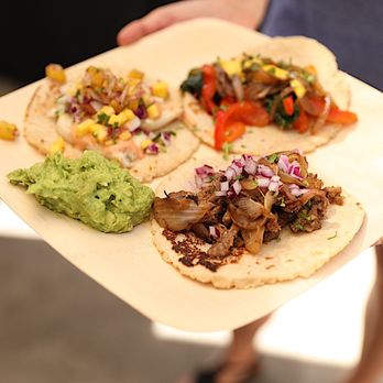 Nomada - a person holding a plate of food - Caterers Near Me - Irvine, California Nomada - a person holding a plate of food - Caterers Near Me - Irvine, California