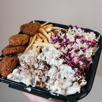 GermanYumTruck - a person holding a tray of food - German Near Me - Anaheim, California GermanYumTruck - a person holding a tray of food - German Near Me - Anaheim, California