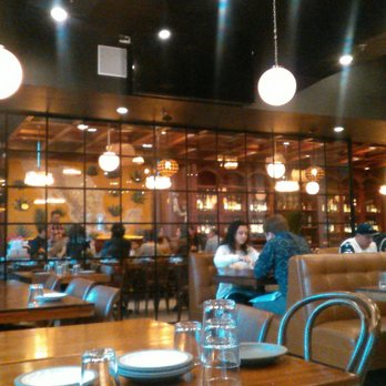 Madre - dIning room; large seating section behind glass partition in the background - Mexican Near Me - Torrance, California