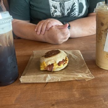 Hando Coffee Bar - Mac Brew (left), Egg Benny Sandwich, Seasonal Butterscotch Iced latte (right) - Coffee & Tea Near Me - Manvel, Texas