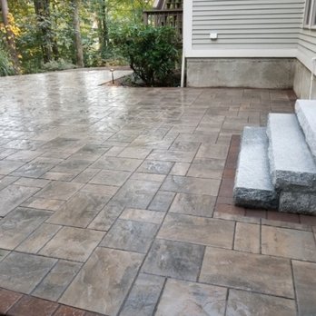 Innovative Landscaping - a concrete patio with steps - Lawn Services Near Me - Acton, Massachusetts