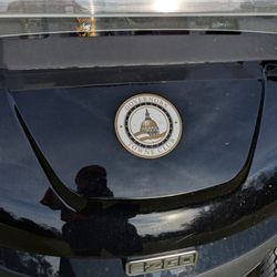 E-Z-GO all-electric golf cart with Governors Towne Club logo on front.