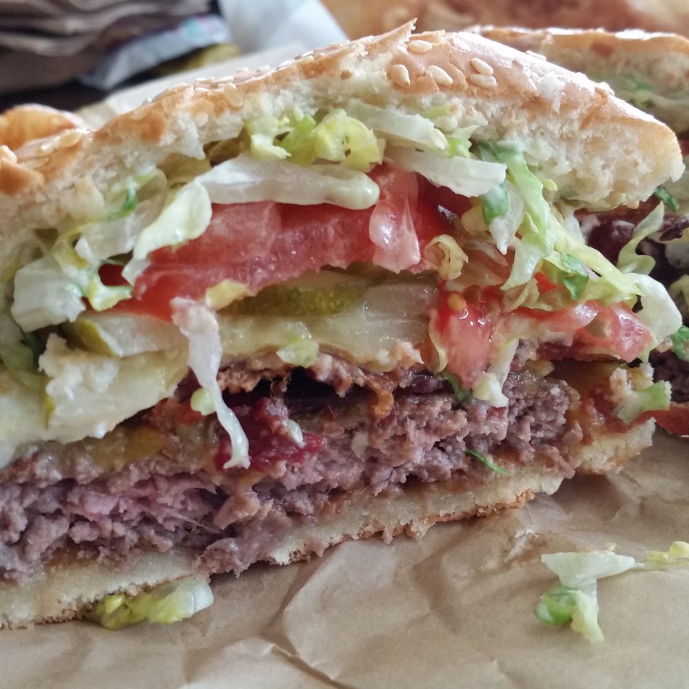 Uneeda Burger - Cross section of classic burger with cheddar, bacon, and egg. - Burgers Near Me - Seattle, Washington Uneeda Burger - Cross section of classic burger with cheddar, bacon, and egg. - Burgers Near Me - Seattle, Washington