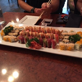 Sushi Bar - California rolls surround the crunchy roll on the ends the middle is two Detroit rolls and the Tokyo roll. - Sushi Bars Near Me - Wyandotte, Michigan Sushi Bar - California rolls surround the crunchy roll on the ends the middle is two Detroit rolls and the Tokyo roll. - Sushi Bars Near Me - Wyandotte, Michigan