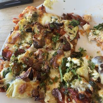 Cafe Karibo - Mediterranean flat bread with pieces already eaten - Seafood Near Me - Fernandina Beach, Florida Cafe Karibo - Mediterranean flat bread with pieces already eaten - Seafood Near Me - Fernandina Beach, Florida