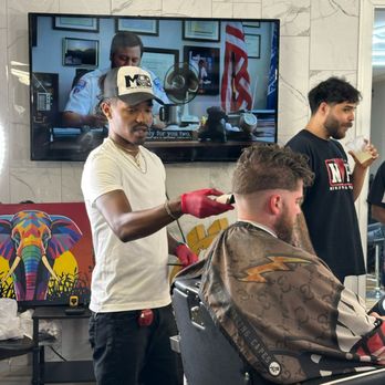 Members Only Barbershop - Leejon with customer and Owner Joc in the background - Barbers Near Me - Manassas, Virginia Members Only Barbershop - Leejon with customer and Owner Joc in the background - Barbers Near Me - Manassas, Virginia