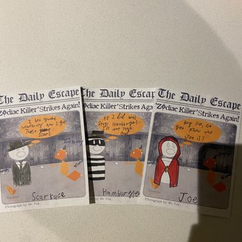 Fox in a Box - Three illustrated cards from The Daily Escape are displayed on a white surface. Each card features a character drawing with handwritten notes in orange speech bubbles. The first card shows a character in a suit with a hat, labeled 'Scarface,' with a note about being worried about scars. The second card depicts a character in a striped shirt labeled 'Hamburger,' with a note about staying away from hamburgers. The third card shows a character with a red hood labeled 'Joe,' with a note asking if Joe is the person in the photo. All cards include the logo 'foxbox' and are credited to Mr. Fox as the photographer. - Escape Games Near Me - Chicago, Illinois