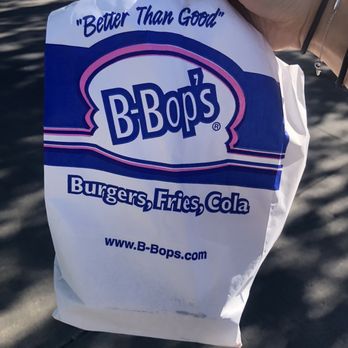 B-Bop's - a hand holding a bag of burgers - Burgers Near Me - Ankeny, Iowa