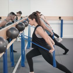 Physique57 - Brooklyn - Lunging position and simultaneously pulling on bands for tricep kickbacks!
