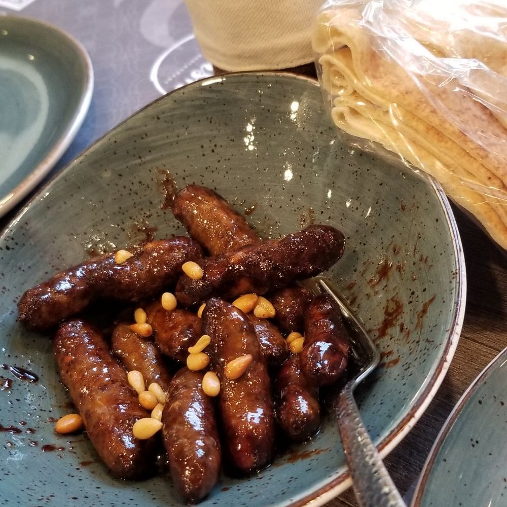 MAKANEK (appetizer. Lil beef sausages with pomegranate molasses and pine nuts). MAKANEK (appetizer. Lil beef sausages with pomegranate molasses and pine nuts).