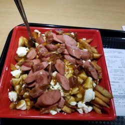 Planète Poutine - Full plate of poutine with my choice of pork (cut up hot dogs) as an added touch.