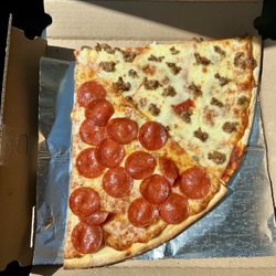 Northshore Pizza Company - Huge Thin crust pizza slices - pepperoni and sausage