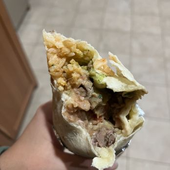 Taqueria La Cumbre - a hand holding a burrito - Mexican Near Me - San Mateo, California Taqueria La Cumbre - a hand holding a burrito - Mexican Near Me - San Mateo, California