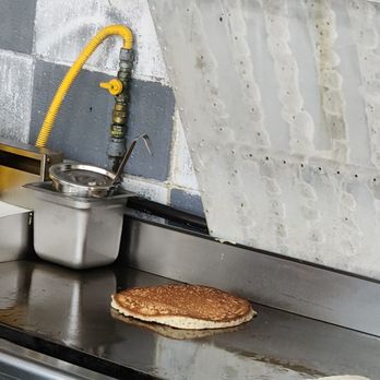 Wings Cafe - a pancake being prepared on the stove - American Near Me - Shirley, New York