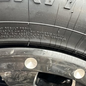 Walmart Supercenter - Scratched wheels.... - A tire with visible tread and sidewall markings, including mounting instructions, and metal screws attached to the rim. - Department Stores Near Me - Catskill, New York