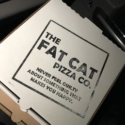 a person holding a box of pizza