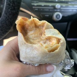 Bean and cheese burrito with mole and sour cream in the middle. Bean and cheese burrito with mole and sour cream in the middle.