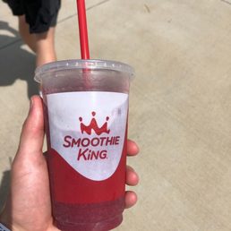 a hand holding a smoothie a hand holding a smoothie