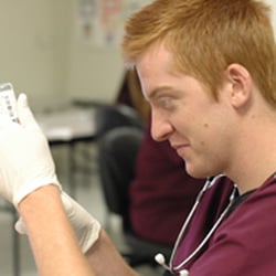 Cambridge Junior College Medical Assistant student getting some hands-on experience with injections.
