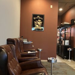 Cigar Town and Lounge - Cigar Town Herndon lounge. Seats that look like recliners against the wall.