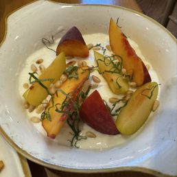 Summer refresh-- peach caprese floating in burrata. Summer refresh-- peach caprese floating in burrata.