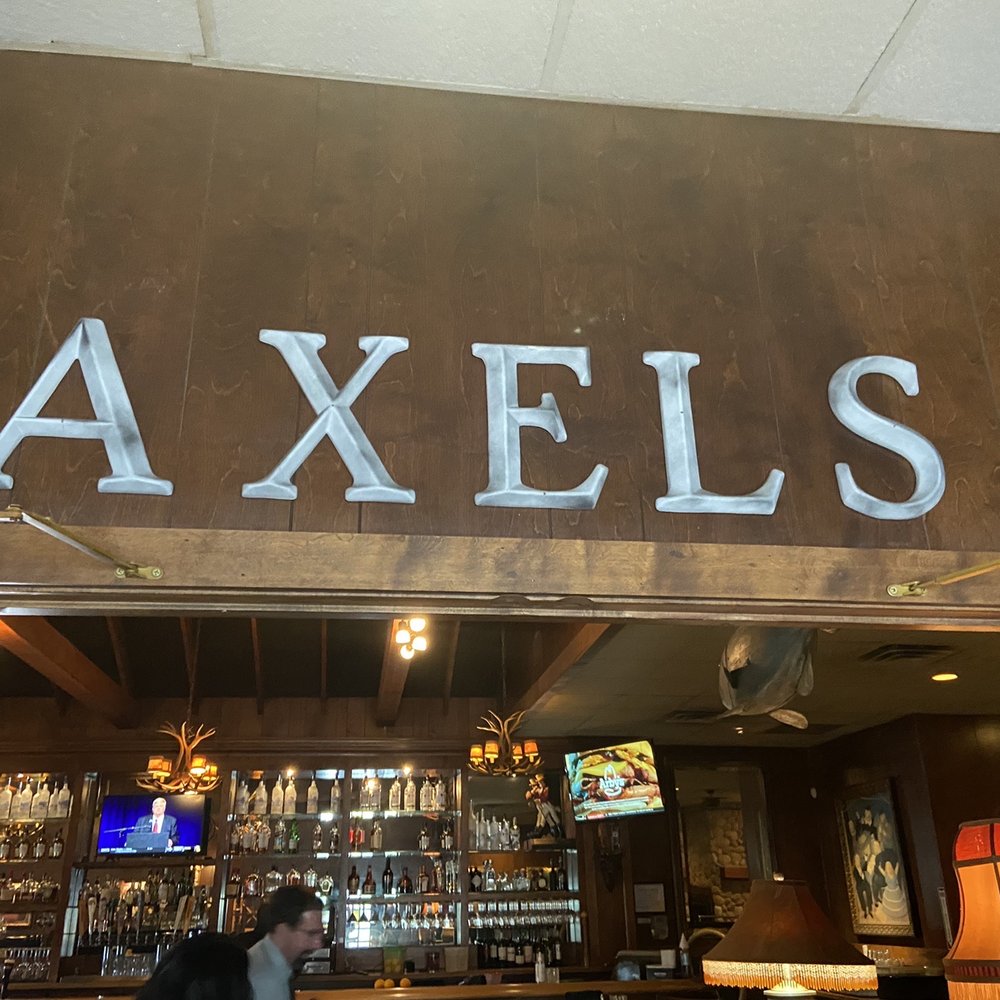 Axel's Restaurants - a man sitting at a bar - Seafood Near Me - Chanhassen, Minnesota Axel's Restaurants - a man sitting at a bar - Seafood Near Me - Chanhassen, Minnesota