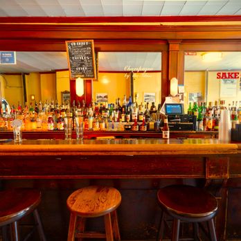 Tile Bar - a row of bar stools in front of a bar - Dive Bars Near Me - New York, New York Tile Bar - a row of bar stools in front of a bar - Dive Bars Near Me - New York, New York