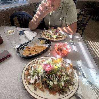 Los Amigos Restaurant - That cheese pull! She split the nachos for us! - Mexican Near Me - Terra Bella, California