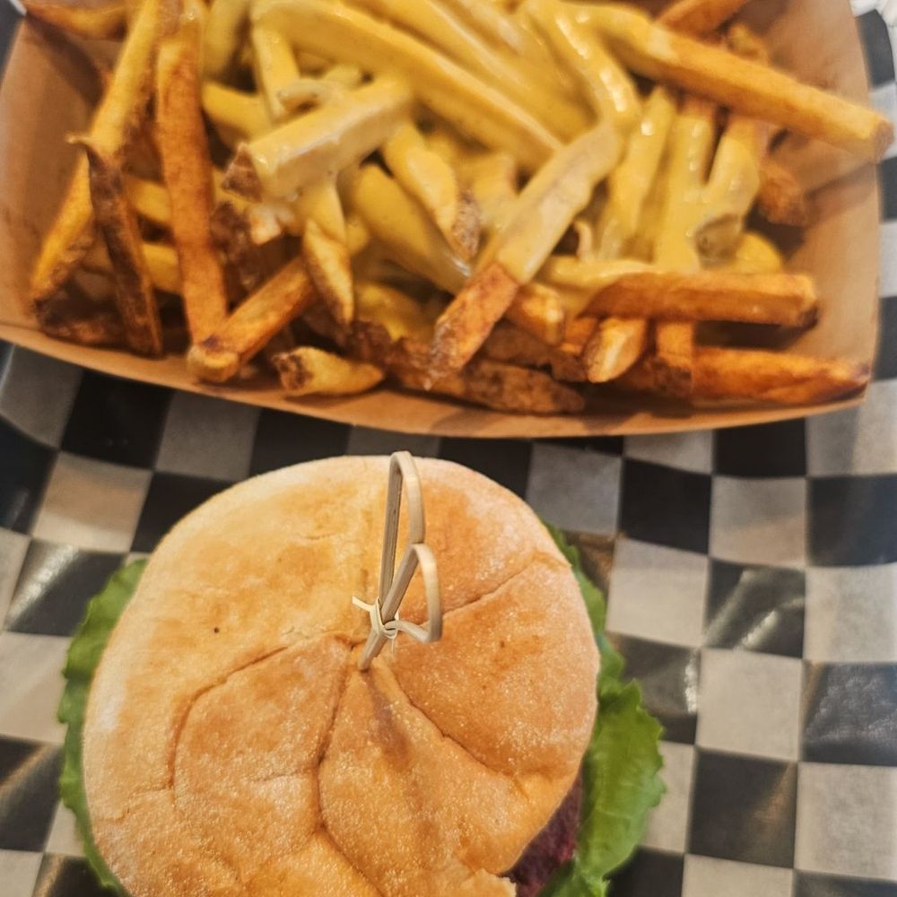 Beet burger with Chipotle sauce and vegan cheese fries. Beet burger with Chipotle sauce and vegan cheese fries.