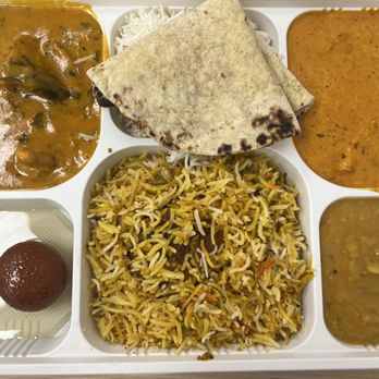 Simply Indian Restaurant - Thali meat box (clockwise from top left: Mango chicken , rice and roti, butter chicken, dal, biryani chicken, Gulab Jamun) - Indian Near Me - Bellevue, Washington Simply Indian Restaurant - Thali meat box (clockwise from top left: Mango chicken , rice and roti, butter chicken, dal, biryani chicken, Gulab Jamun) - Indian Near Me - Bellevue, Washington