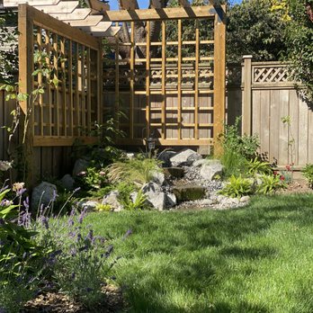 Helpful Home Services - a backyard with a pergolated trellis - Landscaping Near Me Helpful Home Services - a backyard with a pergolated trellis - Landscaping Near Me