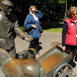 GuideCompaniet - Our guide, Theresa, in red, explaining statues