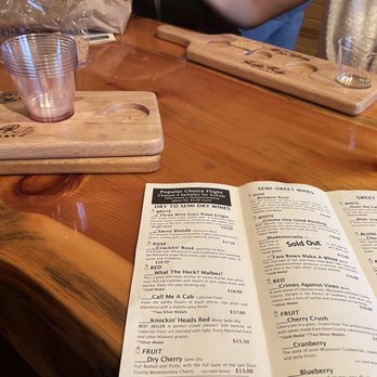 Harbor Ridge Winery - a menu and a glass on a wooden table - Wineries Near Me - Egg Harbor, Wisconsin