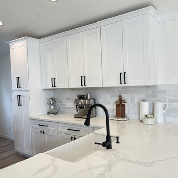 Kinetic Builders - a kitchen with white cabinets and marble countertops - General Contractors Near Me - Citrus Heights, California Kinetic Builders - a kitchen with white cabinets and marble countertops - General Contractors Near Me - Citrus Heights, California