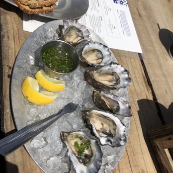 Hog Island Oyster - Raw oysters with delicious crackers on cheese plate in the back - Seafood Near Me - Marshall, California