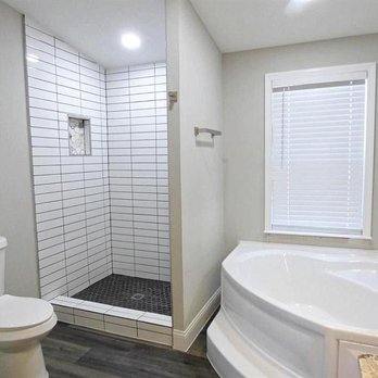 Solotzo Roofing - a bathroom with a shower, toilet, and bathtub - Roofing Near Me Solotzo Roofing - a bathroom with a shower, toilet, and bathtub - Roofing Near Me