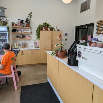 Sparrows Coffee - Counter, waiting area, and cream and sugar counter. The door in the back leads into Kingma's - Coffee & Tea Near Me - Grand Rapids, Michigan
