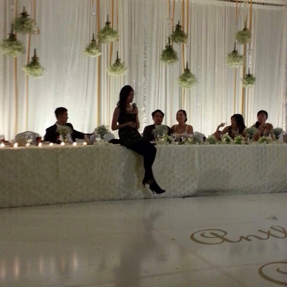 Taken with mobile phone. I loved the simple back drop for my head table at our wedding. Upside down vases + white dance floor