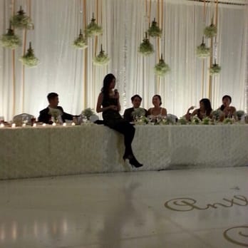 Prestige Events - Taken with mobile phone. I loved the simple back drop for my head table at our wedding. Upside down vases + white dance floor - Florists Near Me - Houston, Texas