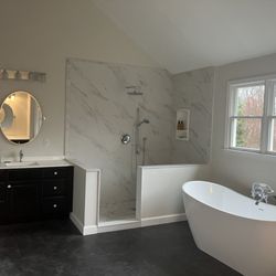 Hammer Away General Contracting - Custom walk-in shower with bench seating and freestanding tub with exposed plumbing tub fill and handheld device.