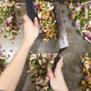 Pita Pit - a person cutting up a pita with a knife - Sandwiches Near Me - Burlington, Ontario Pita Pit - a person cutting up a pita with a knife - Sandwiches Near Me - Burlington, Ontario