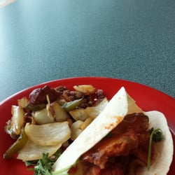 Sausage, peppers, and onion over house-made corned beef hash, and a fish taco!