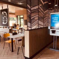 McDonald's - The digital ordering boards and modern dining area.