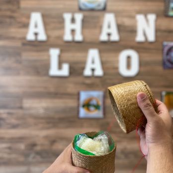Ahan Lao - a person holding a straw hat in front of a sign that says ahan laoo - Laotian Near Me - Chula Vista, California Ahan Lao - a person holding a straw hat in front of a sign that says ahan laoo - Laotian Near Me - Chula Vista, California