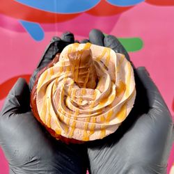 Glazed and Confused - The Raider! Our chocolate glazed donut, topped with chocolate cream, caramel drizzle, and a Twix bar!