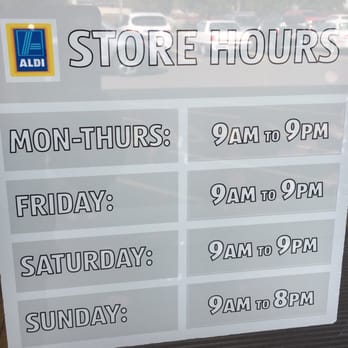 ALDI - a store hours sign in a window - Grocery Near Me - Langhorne, Pennsylvania