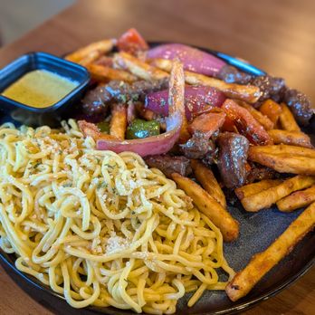 Sona Fusion Kitchen - Lomo Saltado Shaken Fries With Filet Mignon, Subbed Rice For Garlic Noodles - Asian Fusion Near Me - Anaheim, California Sona Fusion Kitchen - Lomo Saltado Shaken Fries With Filet Mignon, Subbed Rice For Garlic Noodles - Asian Fusion Near Me - Anaheim, California