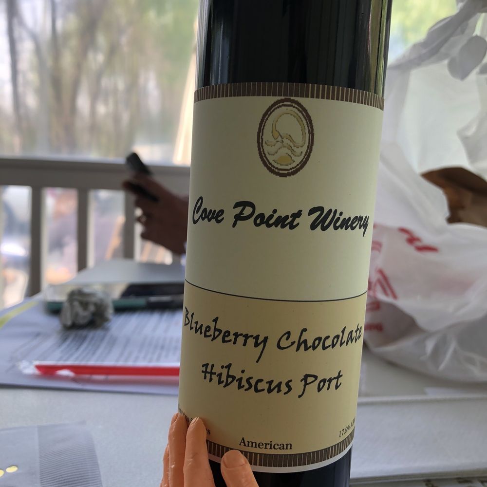 Cove Point Winery - a hand holding a bottle of wine - Wineries Near Me - Lusby, Maryland Cove Point Winery - a hand holding a bottle of wine - Wineries Near Me - Lusby, Maryland